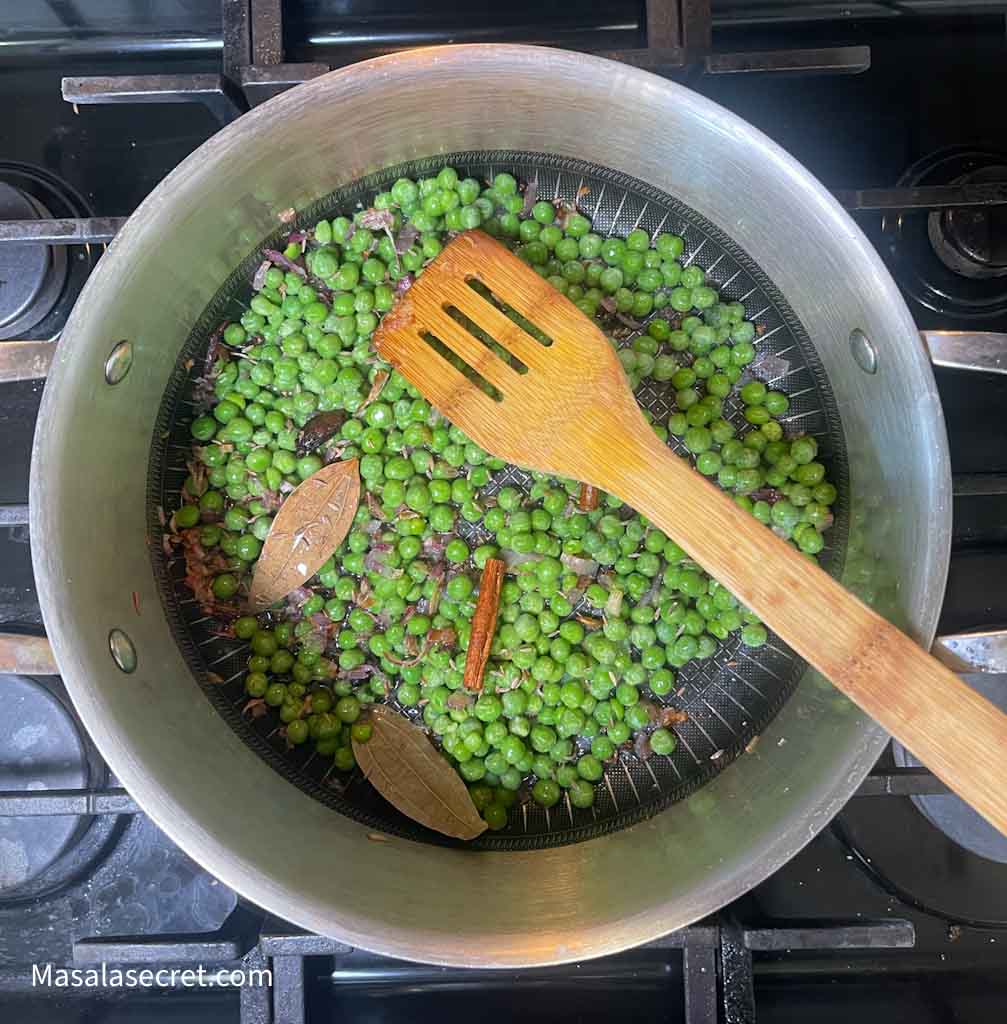 Sauté the peas with the onions.