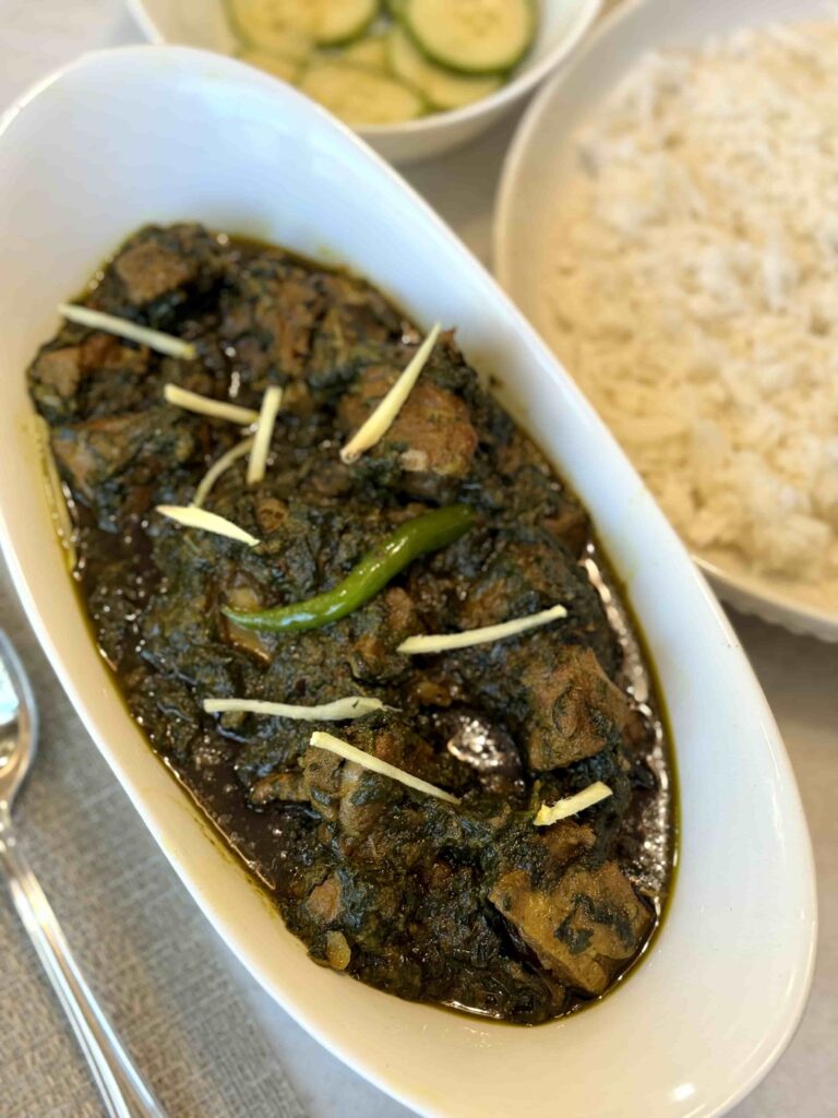 Palak Gosht serving in white dish
