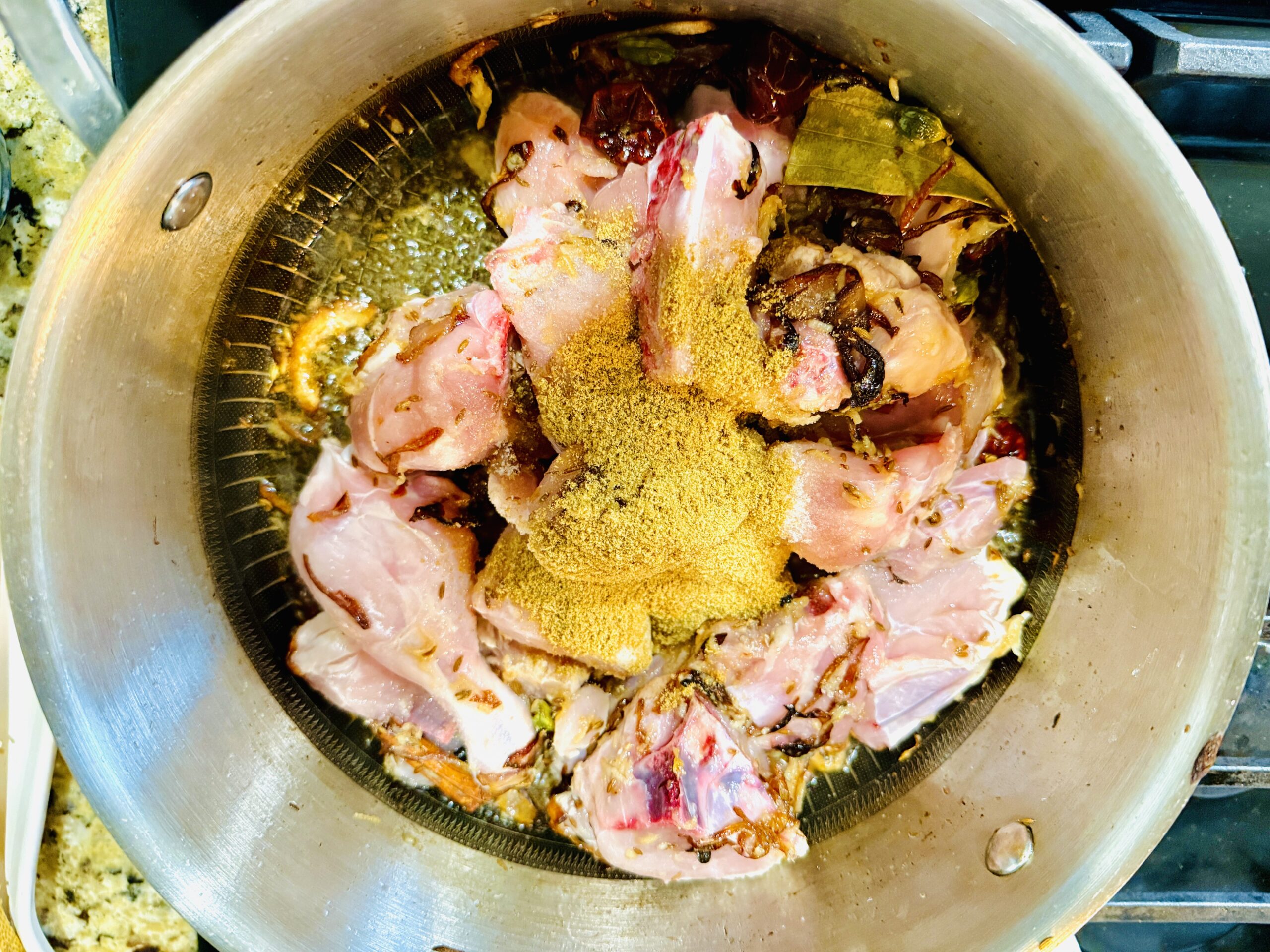 Add chicken and spices in the onion